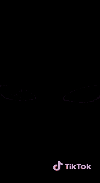 a close up of a person 's eyes on a black background with a tiktok logo in the corner .