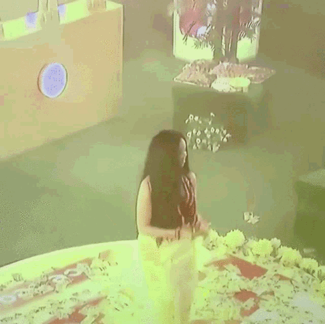 a woman in a red top and white skirt is dancing .