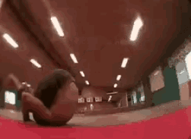 a person is doing a trick on a red carpet in a room .