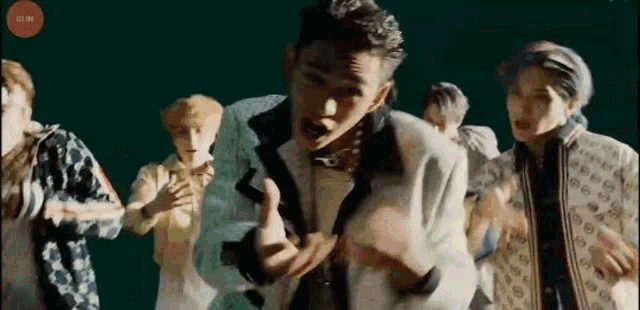 a group of young men are dancing together in a room .