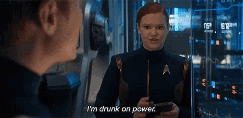 a woman says i 'm drunk on power while holding a phone