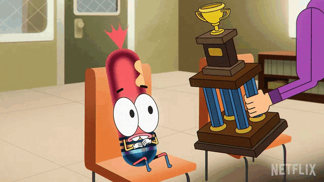 a cartoon character is sitting in a chair next to a trophy that says netflix on it