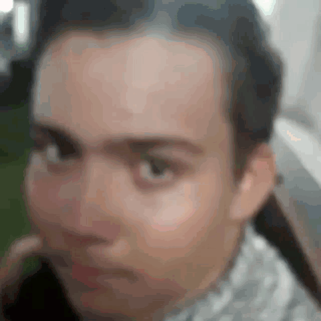 a blurry picture of a man 's face with a few spots on it