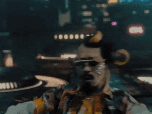 a man with horns on his head is wearing sunglasses and a shirt
