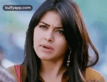 a close up of a woman making a funny face with her mouth open .