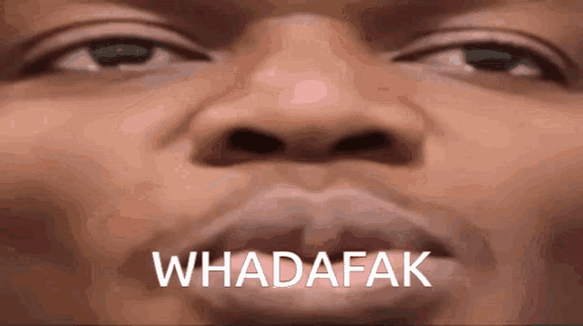 a close up of a man 's face with the word whadafak written on it