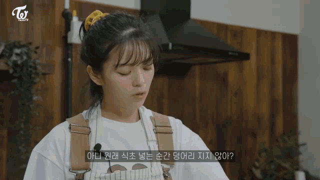 a woman in a kitchen with a twice tv logo on the bottom