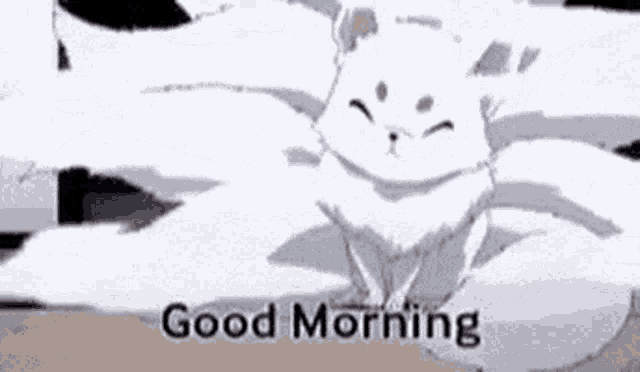 a white cat is sitting on a bed with the words `` good morning '' written next to it .