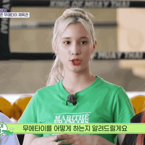 a girl in a green shirt that says marithe blanc on it