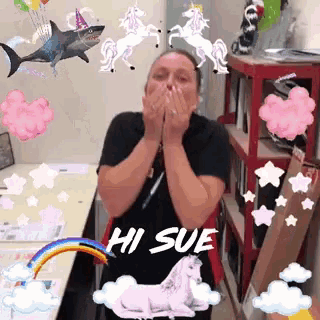 a woman wearing a black shirt that says hi sue is surrounded by unicorns and sharks