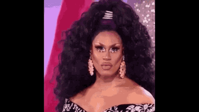 a drag queen with a ponytail and earrings is wearing a black dress and purple hair .