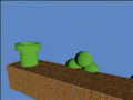 a green pipe is sitting on top of a brick wall next to a pile of green balls .
