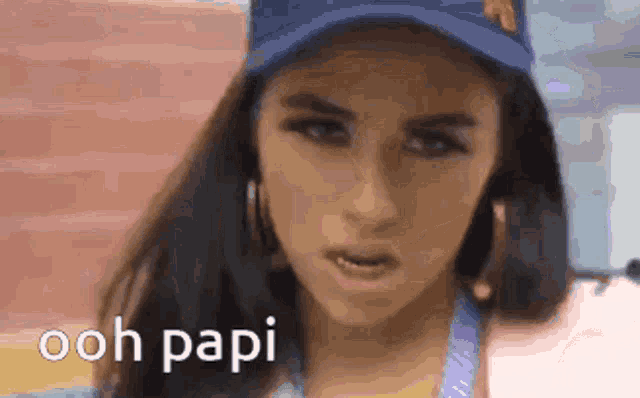 a close up of a woman wearing a blue hat with the words ooh papi written on it