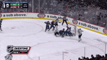 a hockey game is being played with a sub above banner