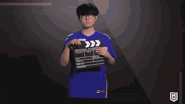 a man holding a clapper board that says universal studios