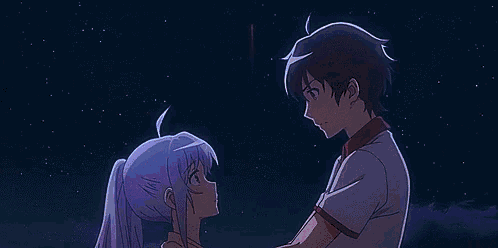 a boy and a girl are looking at each other while watching fireworks .