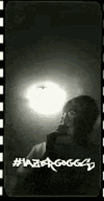 a black and white photo of a person taking a selfie with a helicopter in the background .