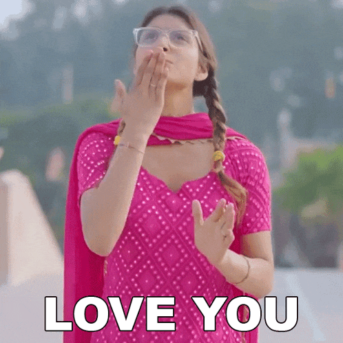 a woman in a pink dress is blowing a kiss with the words love you written below her