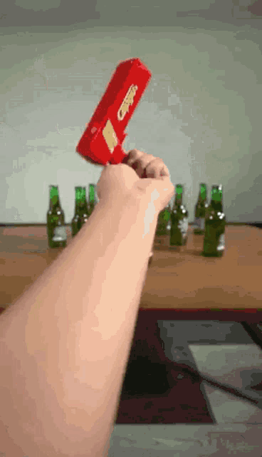 a person is holding a red box that says coca-cola on it