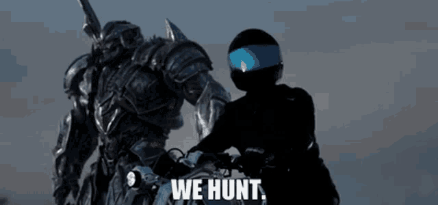 a man is riding a motorcycle next to a robot that says we hunt .