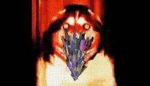 a close up of a person 's face with a purple flower in their mouth
