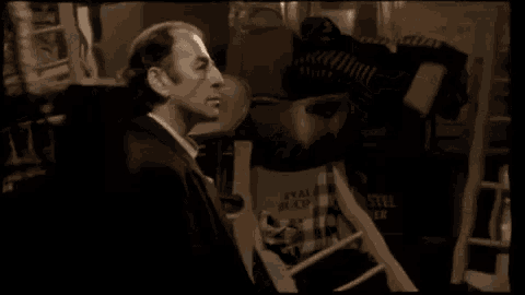a couple of men are standing next to each other in a room .