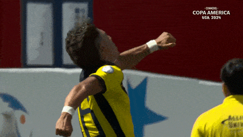 a soccer player celebrates a goal in front of a screen that says copa america usa 2021