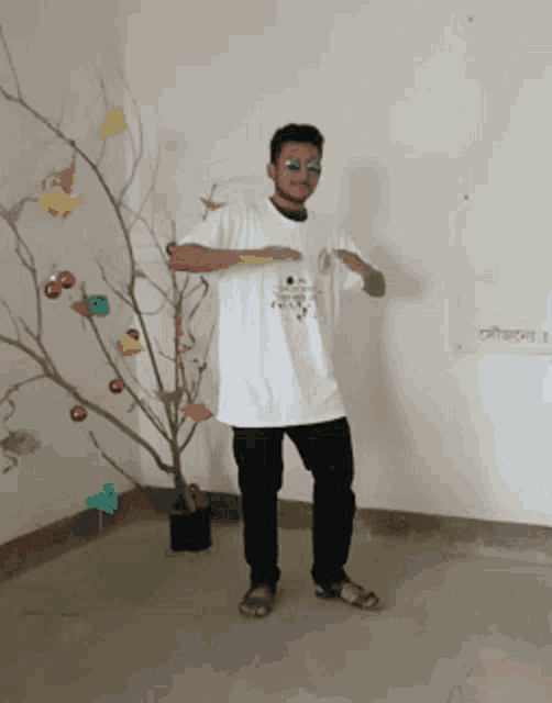 a man wearing sunglasses and a white shirt that says ' freedom ' on it is dancing in front of a christmas tree