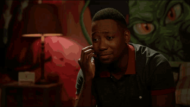 a man talking on a cell phone with the words okay baaaby written on the bottom