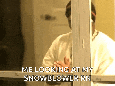 a man wearing a mask is looking out a window and says `` me looking at my snowblower rn '' .