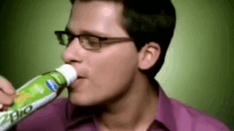 a man with glasses is drinking from a bottle that says bio on it
