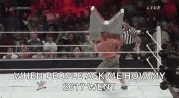 a man is holding a flag in a wrestling ring and says `` when people ask me how my 2017 went ''