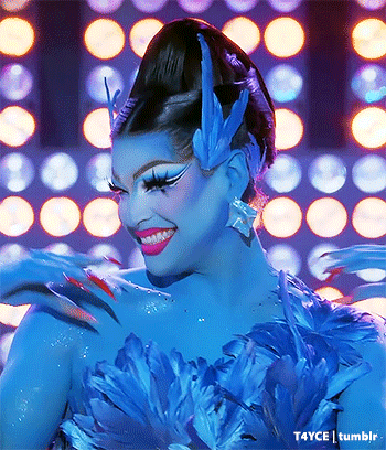 a woman with blue paint on her face and flowers on her shoulder