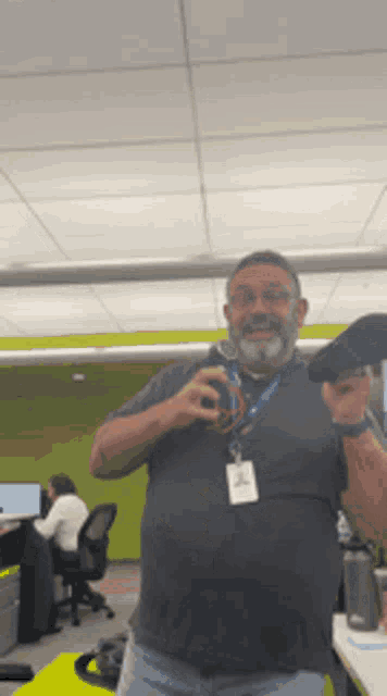 a man with a name tag that says ' a ' on it is standing in an office