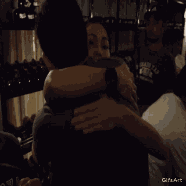 a gif of a woman hugging a man with the words gifs art below