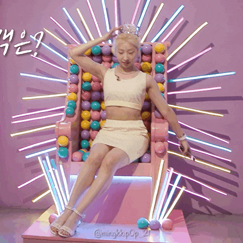 a woman is sitting in a chair with balls on it