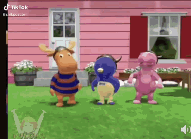 a group of three cartoon characters standing in front of a pink house .
