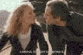 a man and a woman are kissing each other in a movie .