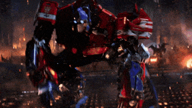 a red and blue robot with the number 3 on its arm