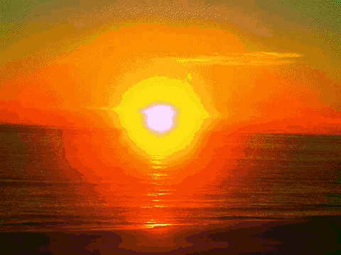 the sun is setting over the ocean