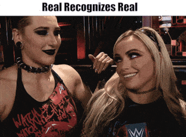 two women standing next to each other with the words real recognizes real above them