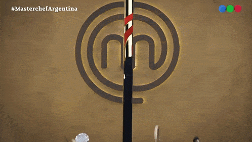 a man stands in front of a masterchef logo