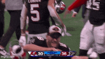 a football player with the number 5 on his jersey is kneeling down on the field .