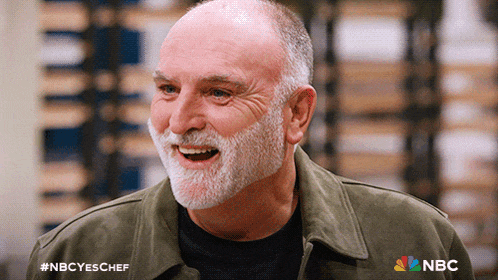 a man with a beard is smiling with the nbc logo on the bottom right