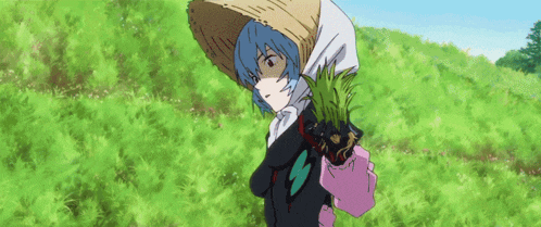 a girl in a straw hat is holding a plant in her hand