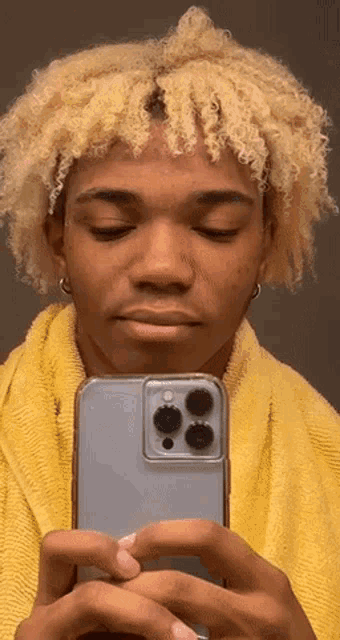 a man taking a picture of himself with his phone