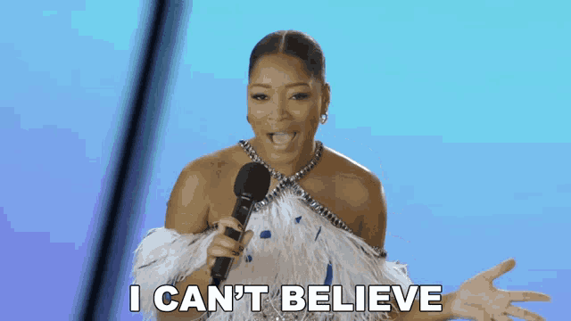 a woman holding a microphone with the words i can 't believe below her