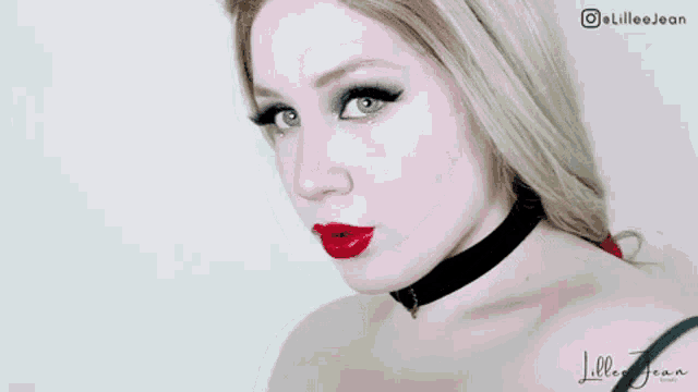 a woman wearing red lipstick and a black choker has the name lillee jean written on the bottom
