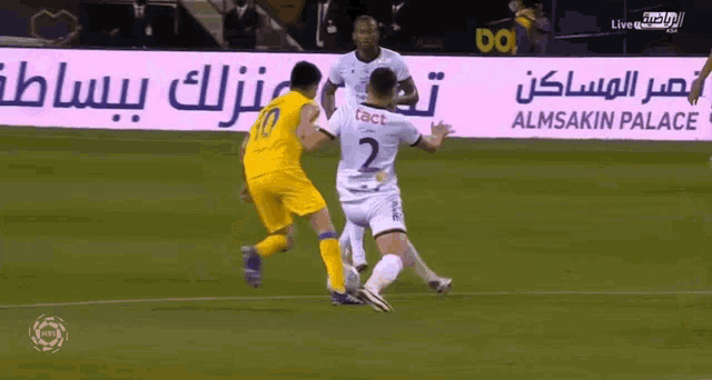 a soccer game is being played in front of a sign that says almsakin palace