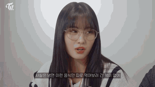 a woman wearing glasses and a sweater with the word twice written on it